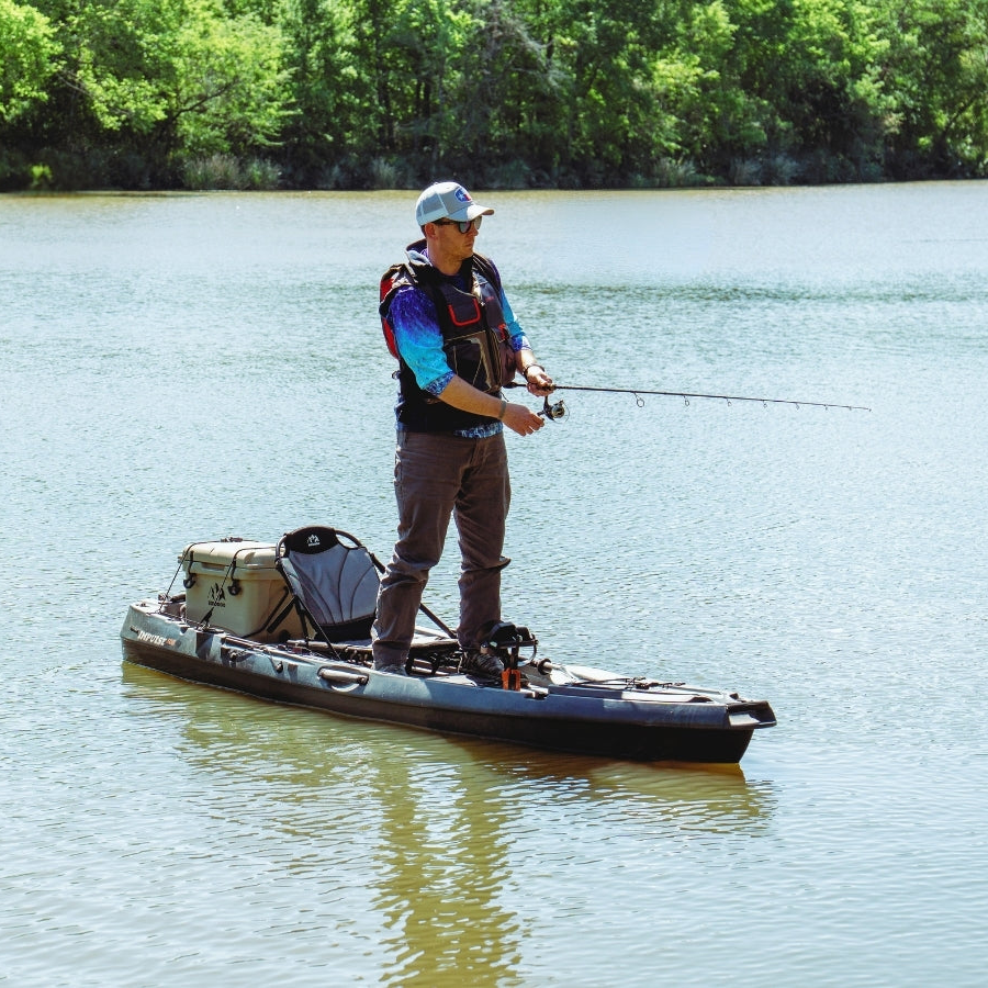 Hoodoo Impulse 105 Fin Drive Pedal Kayak with cooler and angler standing.